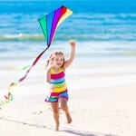 Photo of a Young Girl Holding a Kite—Good, Old-Fashioned Beach Fun!