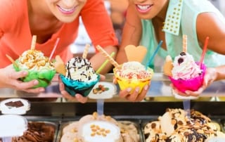 Photo of Two Women Holding a Variety of Ice Cream in Myrtle Beach.