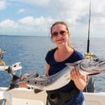 Photo of a Woman Holding a Mackerel on One of the Best Fishing Charters in Myrtle Beach.